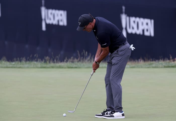 Phil Mickelson putts on the 9th hole during the first round of the U.S. Open golf tournament.